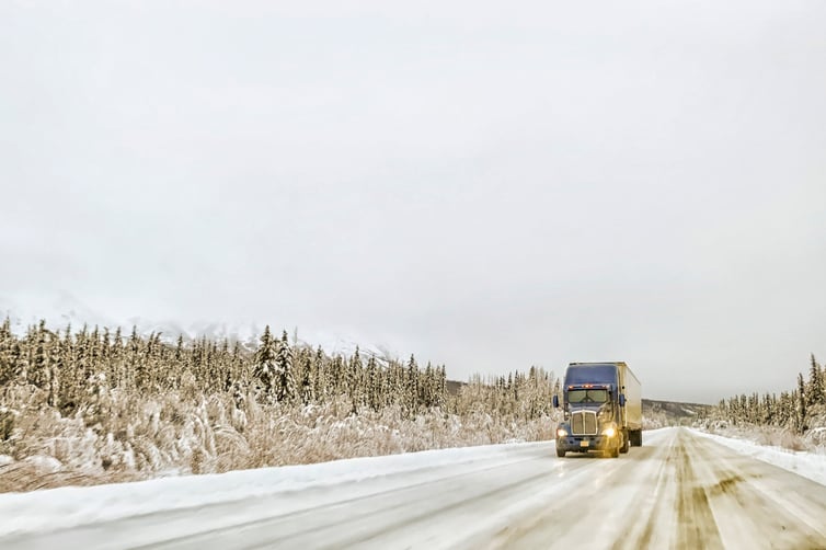 Semi truck driving in winter weather