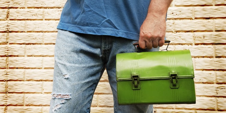 Truck driver holding a lunch pail