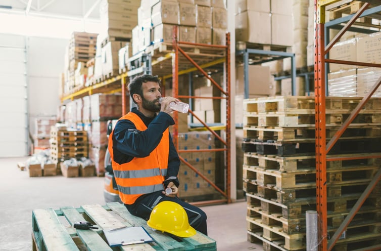 Worker takes a break to drink water and keep hydrated